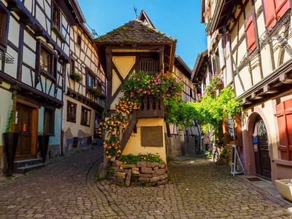 Street with colorful traditional french houses in Eguisheim, France Street with colorful traditional french houses in Eguisheim town of Alsace region, France